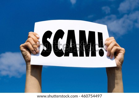 scam concept sign, hands holding white paper with message text alert