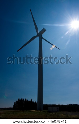 Photo of Wind power silhouette installation in sunny day