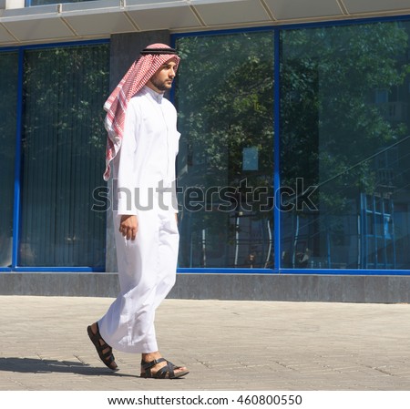 Handsome arabian man walking along the street
 Royalty-Free Stock Photo #460800550