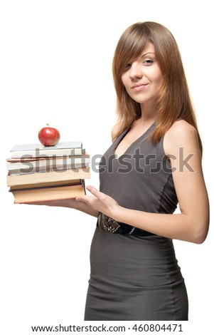 young woman in a grey dress with red apple on a stack of books in her hands