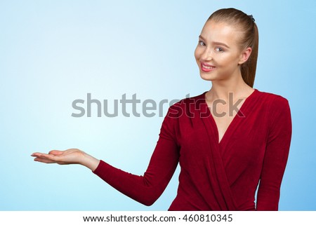 smiling young woman pointing