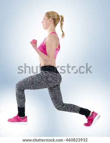 Athletic woman in sports wear lifting weights while doing aerobics.