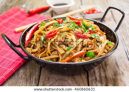 Chicken chow mein a popular oriental dish with noodles and vegetables Royalty-Free Stock Photo #460860631