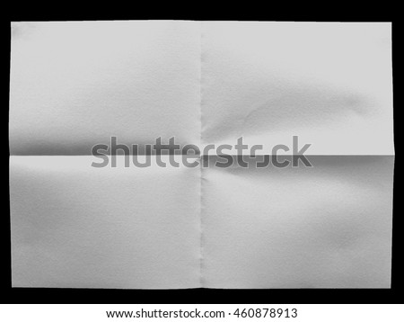 white uneven sheet of paper on the black background