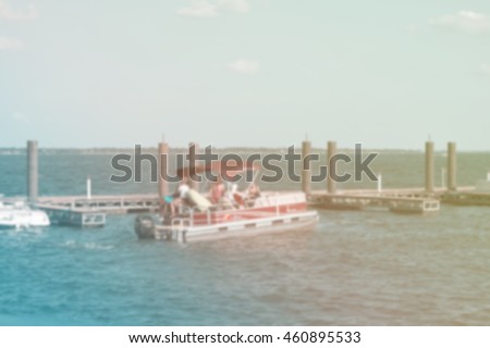 blurry picture of boats pier and lake for background , filtered color tone