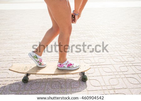 girl riding a longboard near the beach
