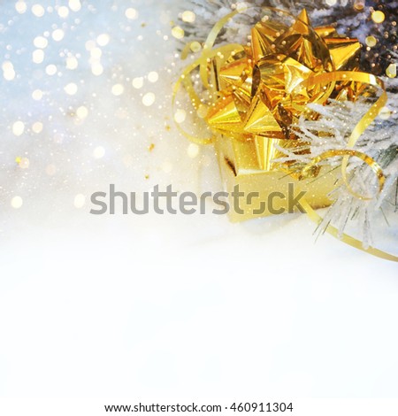 Golden christmas gift in snow