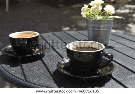 Two coffee cups standing on a table, picture from Gothenburg Sweden.