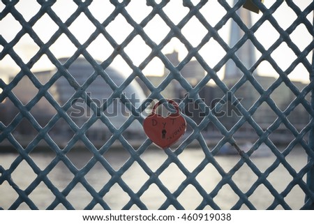 Heart shaped locker on a fence - Tower Bridge fence's locker - Promise - Red heart locker symbolizing love forever on a fence