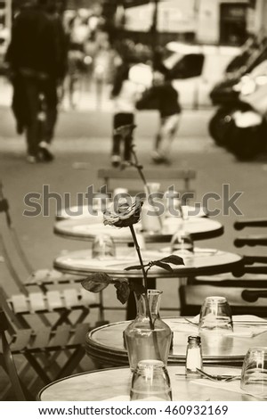 Romantic Parisian cafe. Kids playing at background. Sepia photo.