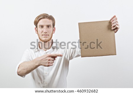 Young Adult Man in White Shirt Holding a Cardboard Inscription