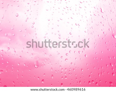 raindrops on glass window, pink sky background