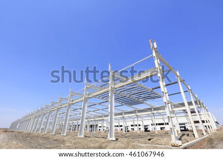 steel girder truss under blue sky, closeup of photo
