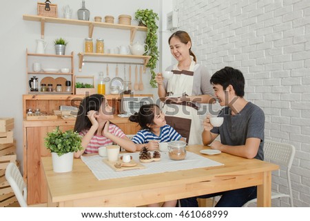 Happy Asian family have a breakfast together in the morning Royalty-Free Stock Photo #461068999