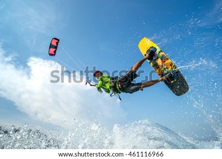 A kite surfer rides the waves
 Royalty-Free Stock Photo #461116966