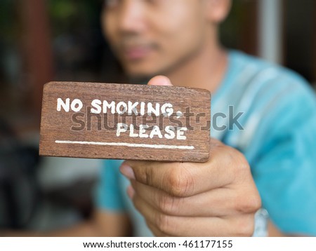 man hold no smoking sign  in coffee shop