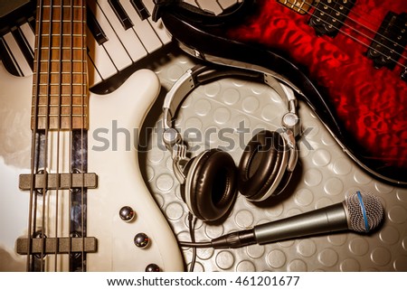 music instruments band the microphone,headphones,bass,electric guitar,electronic piano on floor background.