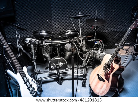 selective focus the  microphone and music instruments the guitar,electric drum,bass,speakers background.