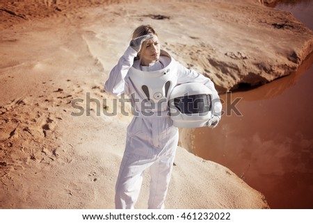 futuristic astronaut without a helmet on another planet, image with the effect of toning Royalty-Free Stock Photo #461232022