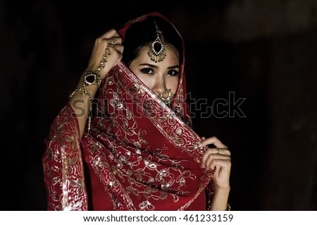 Beautiful Young Asia Woman in red Traditional Clothing with perfect Makeup and Oriental Jewelry