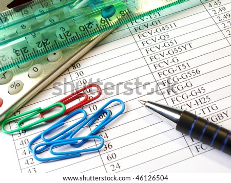 Ruler, pen, paper-clips and calculator against the table.