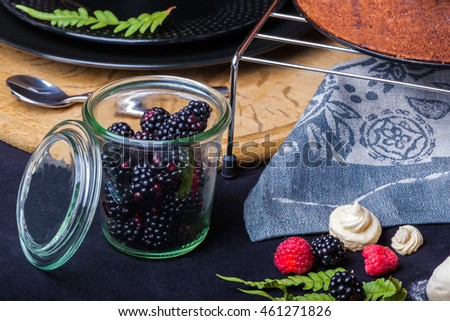 Cake with white chocolate mousse, lime confit, fruits and berries on top as decoration. The process of preparing a tea party with homemade fresh cake.