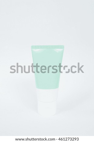 Blank green tube of cream, foam  or gel white plastic package on white background.