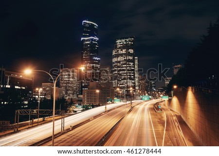 Seattle city view with urban architecture and traffic light trail.