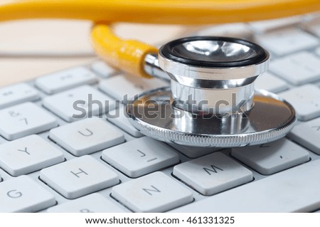 White keyboard and yellow  stethoscope
