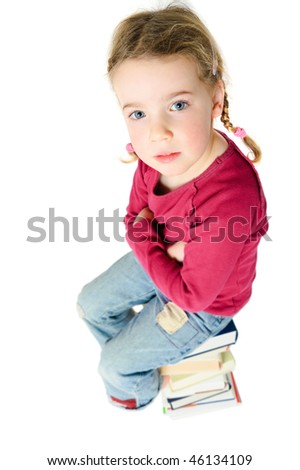 Full isolated studio picture from a young child sitting on some books