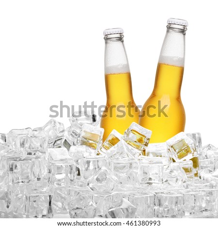 Two yellow bottles of beer in ice cubes  isolated on white background