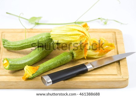  Fresh cropped green Zucchini with yellow flower on white background.