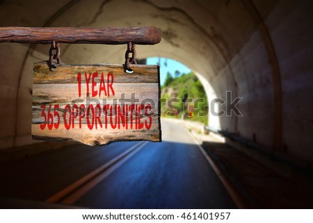 1 year 365 opportunities motivational phrase sign on old wood with blurred background