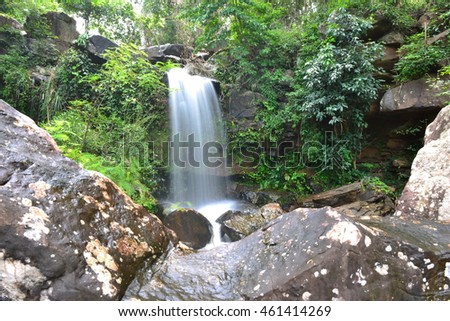 Waterfall in the forest and rocks blurred.