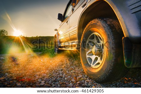 Off-road travel on mountain road. Beautiful mountains sunset Royalty-Free Stock Photo #461429305