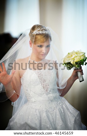 Beautiful bride in a wedding dress with bouquet of flowers