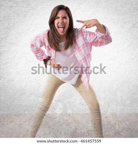 Girl doing victory gesture over textured background