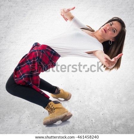 Young girl dancing over textured background