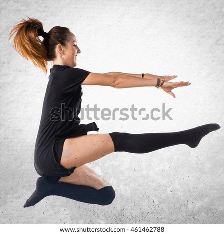 Young girl dancing over textured background