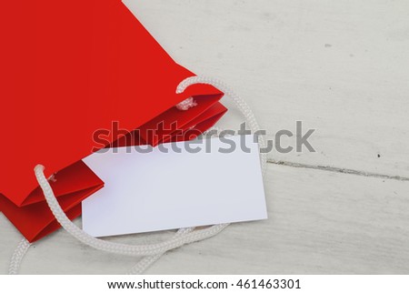 Mockup  business card and gift wrapping red on the red bacground.