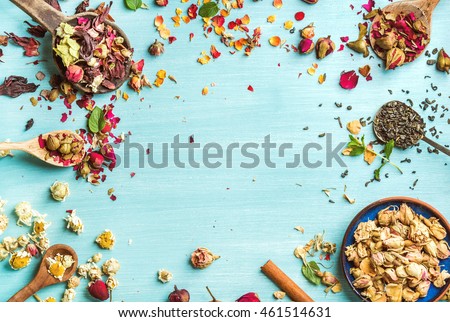 Different herbs for making healthy tea: mint, cinnamon, dried rose in bowl, camomile flowers in spoons over blue painted background, top view, copy space, horizontal composition Royalty-Free Stock Photo #461514631