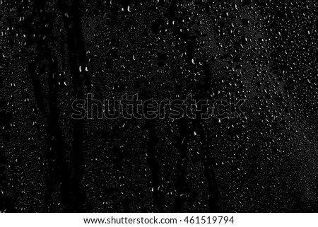 Drops of water on a dark glass texture background Royalty-Free Stock Photo #461519794