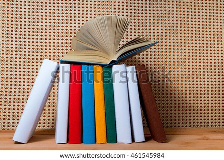 Open book, hardback books on wooden table. Education orange rattan background. Back to school. Copy space for text