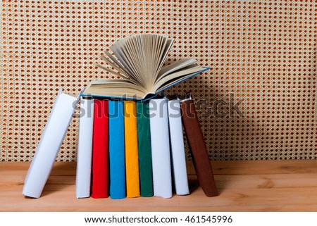 Open book, hardback books on wooden table. Education orange rattan background. Back to school. Copy space for text