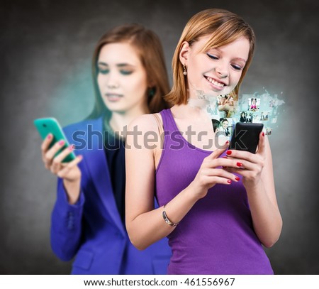 Women looking on smartphone. Elements of this image furnished by NASA