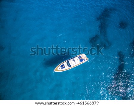 Aerial view of tropical island beach holiday yacht on blue reef ocean Royalty-Free Stock Photo #461566879