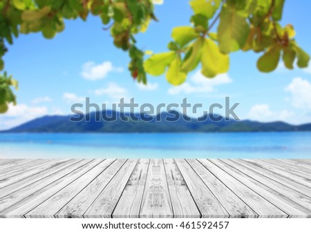 Wood table top on blurred blue sea & sky background, can put or montage your products for display