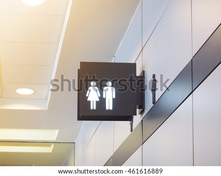 Light box of public restroom sign on the top of the entrance.