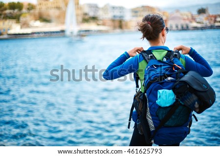 woman tourist walking on the waterfront of Chania bay backround, Crete, Greece