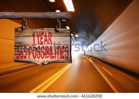 1 year 365 possibilities motivational phrase sign on old wood with blurred background